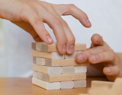 close-up-kid-playing-wooden-tower-game-1-e1731006567334.jpg